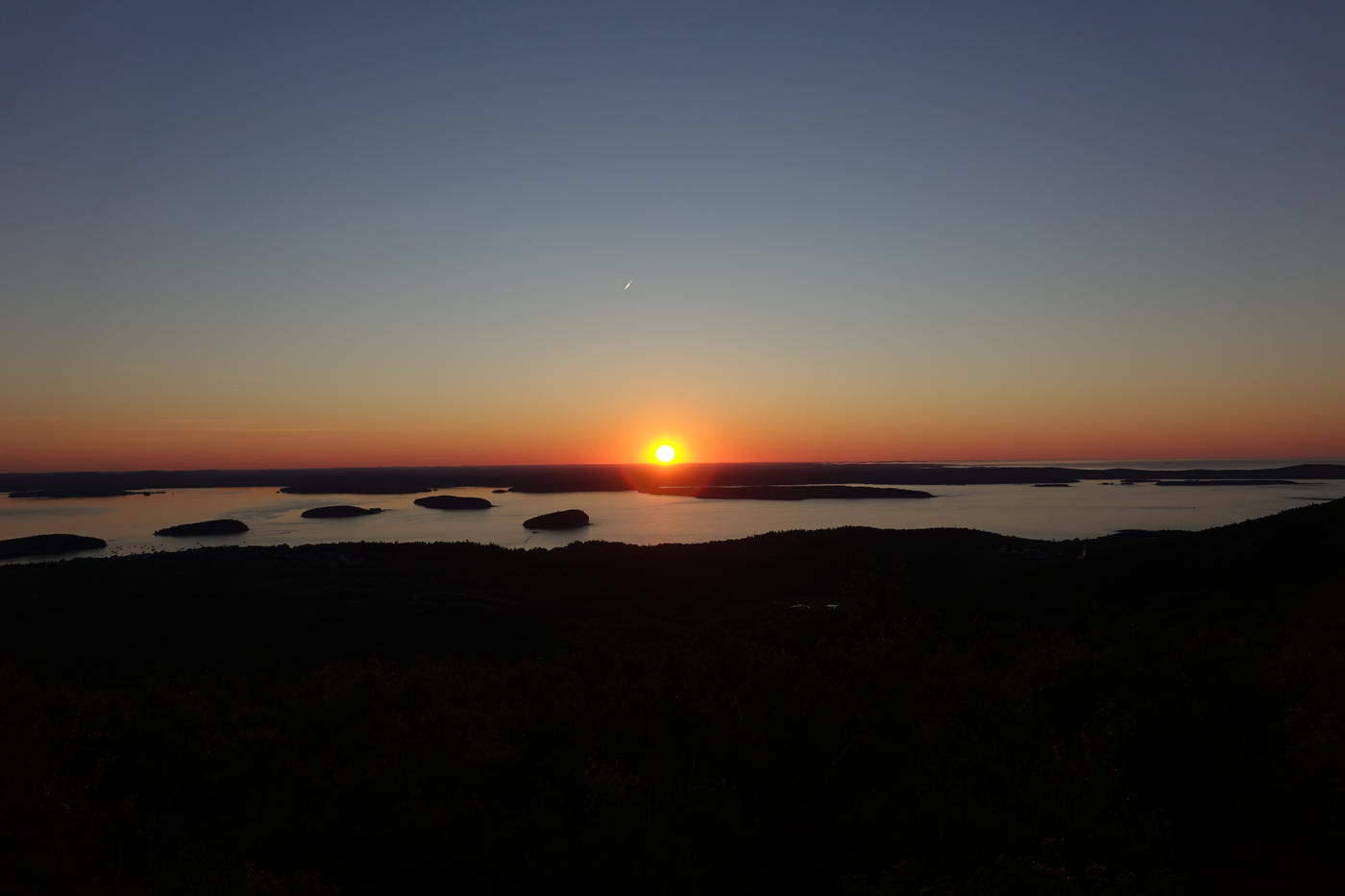 The night sky over the granite summit ridge of Cadillac Mountain, Acadia