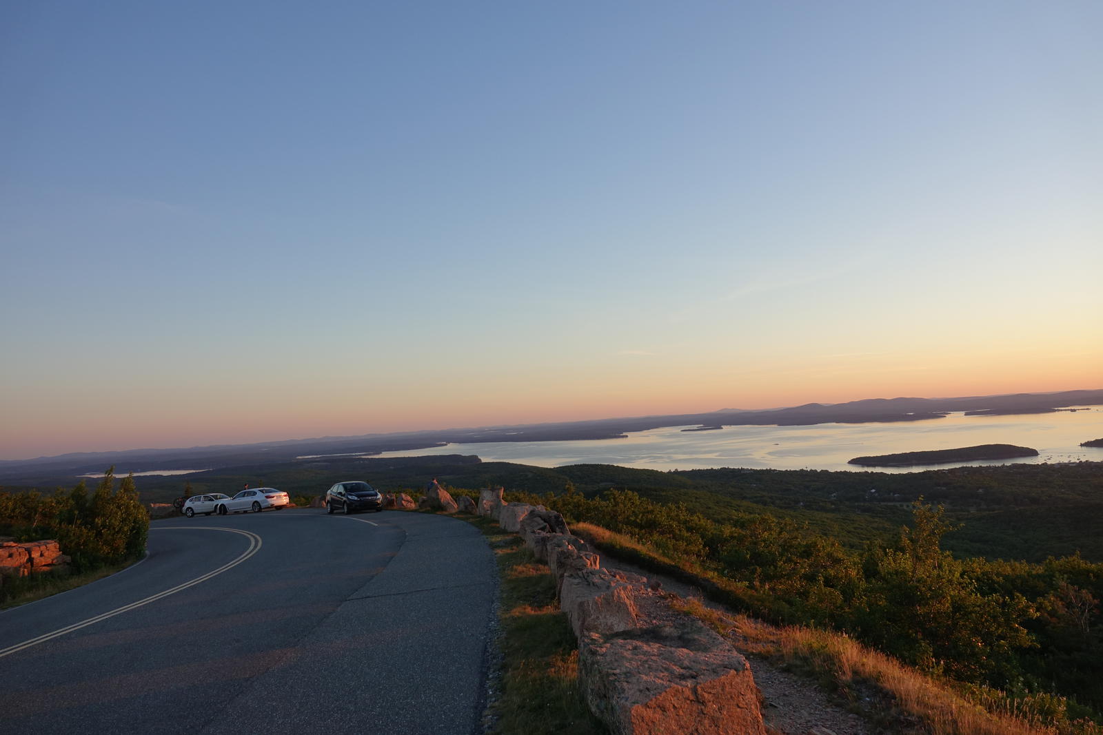 The sun setting from the open granite summit of Cadillac Mountain, Acadia National Park