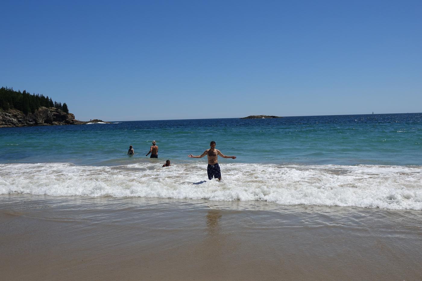 Sand Beach between granite headlands, Acadia National Park, with the Beehive rising behind