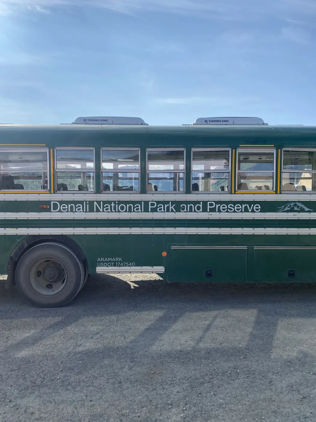 The side of a green Denali National Park and Preserve transit bus