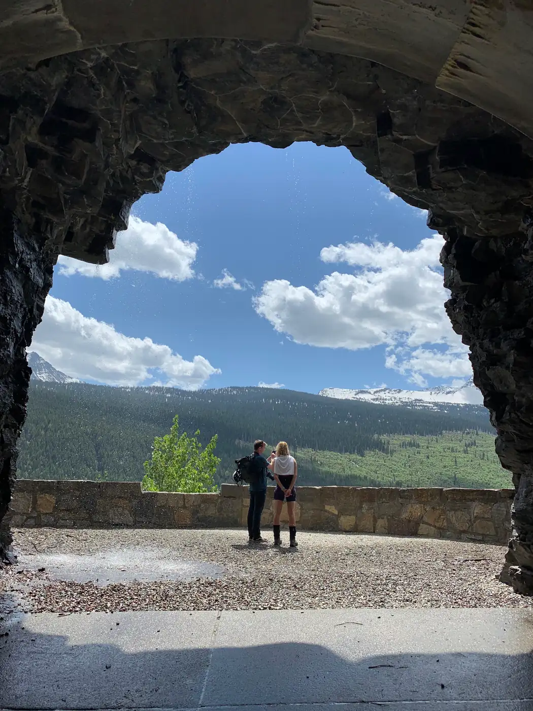The view out through a stone tunnel arch on the Going-to-the-Sun Road