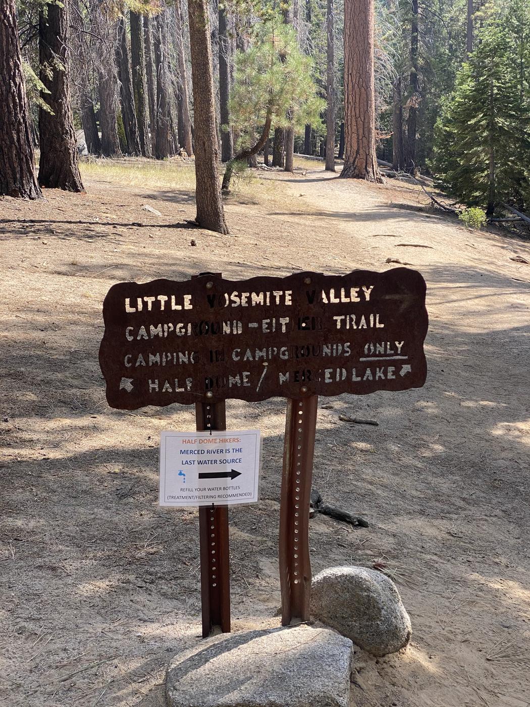 The Little Yosemite Valley trail junction sign, with a notice telling Half Dome hikers the Merced River is the last water source