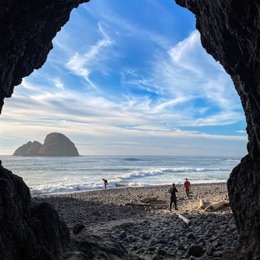 A highway tunnel cutting through a coastal headland on Highway 101